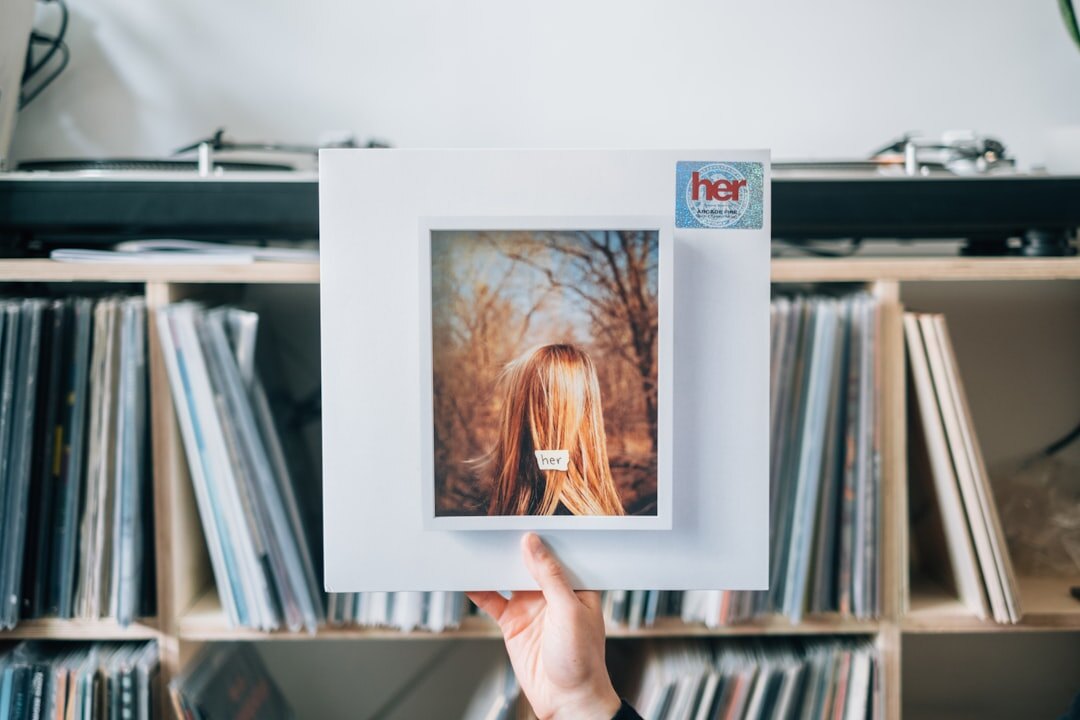 Vintage-style portrait of a Belgian musician holding a vinyl record